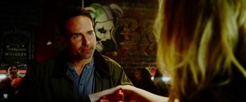 Movie still from “The Prince” (2014), directed by Brian A. Miller – A man looking at a woman in front of a graffiti wall; Close Up shot, Over the shoulder angle