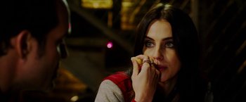 Movie still from “The Prince” (2014), directed by Brian A. Miller – A beautiful young lady holding a piece of food; Close Up shot, Over the shoulder angle