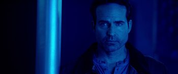 Movie still from “The Prince” (2014), directed by Brian A. Miller – A person in a blue light; Close Up shot, Low angle