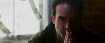 Movie still from “The Prince” (2014), directed by Brian A. Miller – A person with his hand to his face; Close Up shot, Low angle
