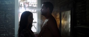 Movie still from “The Prince” (2014), directed by Brian A. Miller – A man and a woman standing next to each other in front of a brick wall; Medium shot, Low angle