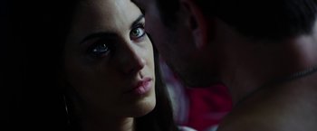 Movie still from “The Prince” (2014), directed by Brian A. Miller – A woman's face and a man's face in the background; Close Up shot, Over the shoulder angle