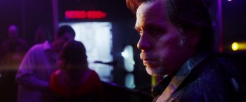 Movie still from “The Prince” (2014), directed by Brian A. Miller – A person wearing a jacket; Close Up shot, Over the shoulder angle