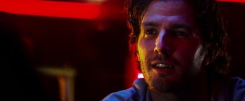 Movie still from “The Prince” (2014), directed by Brian A. Miller – A man's face in a dark room; Close Up shot, Low angle