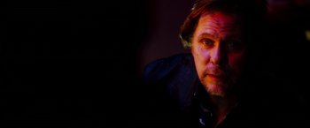 Movie still from “The Prince” (2014), directed by Brian A. Miller – A person wearing a black jacket; Close Up shot, Low angle