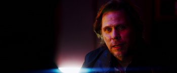 Movie still from “The Prince” (2014), directed by Brian A. Miller – A person wearing a jacket; Close Up shot, Over the shoulder angle