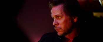 Movie still from “The Prince” (2014), directed by Brian A. Miller – A person looking at the camera; Close Up shot, Low angle