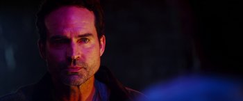 Movie still from “The Prince” (2014), directed by Brian A. Miller – A person wearing a jacket; Close Up shot, Over the shoulder angle