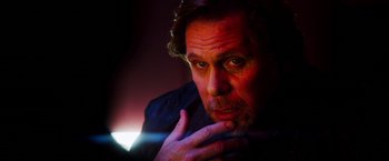 Movie still from “The Prince” (2014), directed by Brian A. Miller – A person with his hand on his chin; Close Up shot, Low angle