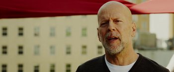 Movie still from “The Prince” (2014), directed by Brian A. Miller – A man with a beard and a white shirt; Close Up shot, Low angle