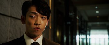 Movie still from “The Prince” (2014), directed by Brian A. Miller – A man in a suit and tie looking at the camera; Close Up shot, Low angle