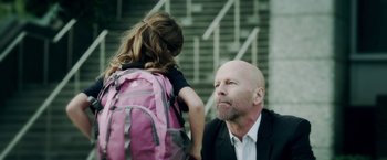 Movie still from “The Prince” (2014), directed by Brian A. Miller – A man and a little girl with a pink backpack; Close Up shot, Over the shoulder angle