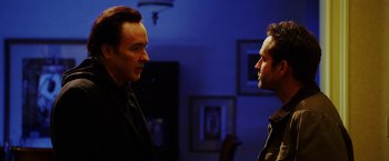 Movie still from “The Prince” (2014), directed by Brian A. Miller – Two men standing next to each other in a room; Close Up shot, Over the shoulder angle