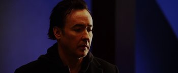 Movie still from “The Prince” (2014), directed by Brian A. Miller – A person wearing a black jacket; Close Up shot, Low angle