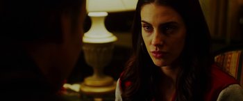 Movie still from “The Prince” (2014), directed by Brian A. Miller – A person sitting in front of a lamp; Close Up shot, Over the shoulder angle