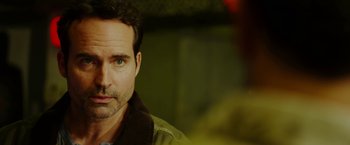 Movie still from “The Prince” (2014), directed by Brian A. Miller – A person wearing a jacket; Close Up shot, Over the shoulder angle