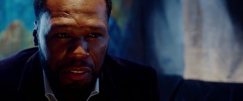 Movie still from “The Prince” (2014), directed by Brian A. Miller – A man's face in a dark room; Close Up shot, Over the shoulder angle