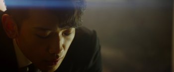 Movie still from “The Prince” (2014), directed by Brian A. Miller – A person with a black shirt and a black hat; Extreme Close Up shot, Low angle