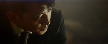 Movie still from “The Prince” (2014), directed by Brian A. Miller – A man's face in a dark room; Close Up shot, Low angle