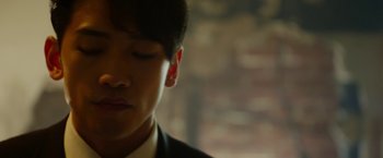 Movie still from “The Prince” (2014), directed by Brian A. Miller – A man in a suit and tie looking down at his face; Extreme Close Up shot, Low angle