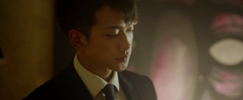 Movie still from “The Prince” (2014), directed by Brian A. Miller – A man in a black suit and a black tie; Close Up shot, Low angle