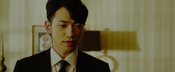 Movie still from “The Prince” (2014), directed by Brian A. Miller – A man in a suit and tie looking to his left; Close Up shot, Low angle