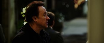 Movie still from “The Prince” (2014), directed by Brian A. Miller – A person wearing a jacket; Close Up shot, Over the shoulder angle