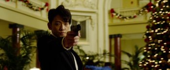 Movie still from “The Prince” (2014), directed by Brian A. Miller – A man holding a gun in his right hand; Close Up shot, Low angle
