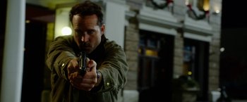 Movie still from “The Prince” (2014), directed by Brian A. Miller – A man holding a gun in his right hand; Close Up shot, Low angle