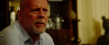 Movie still from “The Prince” (2014), directed by Brian A. Miller – An older man with a goatee is looking at the camera; Close Up shot, Over the shoulder angle