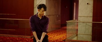 Movie still from “The Prince” (2014), directed by Brian A. Miller – A man in a purple shirt is holding a golf club; Medium shot, Over the shoulder angle