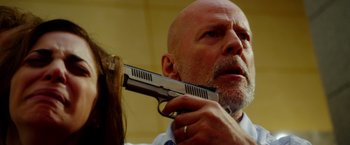 Movie still from “The Prince” (2014), directed by Brian A. Miller – A man with a gun in his mouth and a woman with a ring on his finger; Close Up shot, Low angle