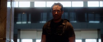 Movie still from “The Prince” (2014), directed by Brian A. Miller – A man wearing a black shirt and a black vest; Close Up shot, Low angle