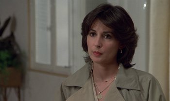 Movie still from “The Professional” (1981), directed by Georges Lautner – A person wearing a jacket; Close Up shot, Over the shoulder angle