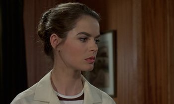 Movie still from “The Professional” (1981), directed by Georges Lautner – A person wearing a white jacket; Close Up shot, Over the shoulder angle