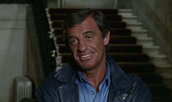 Movie still from “The Professional” (1981), directed by Georges Lautner – A person wearing a jacket; Close Up shot, High angle