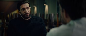 Movie still from “Journal 64” (2018), directed by Christoffer Boe – A man with a beard and a black sweater; Medium shot, Over the shoulder angle