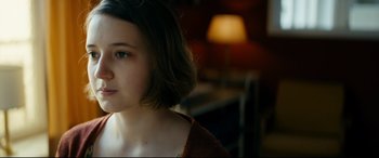 Movie still from “Journal 64” (2018), directed by Christoffer Boe – A woman with short brown hair is looking to her left; Close Up shot, Over the shoulder angle