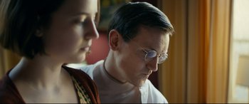 Movie still from “Journal 64” (2018), directed by Christoffer Boe – A man and a woman looking at something on a computer screen; Close Up shot, Low angle