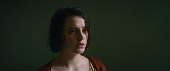 Movie still from “Journal 64” (2018), directed by Christoffer Boe – A young woman is looking into the camera; Close Up shot, Low angle