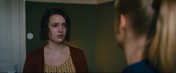 Movie still from “Journal 64” (2018), directed by Christoffer Boe – A woman looking at her reflection in a mirror; Close Up shot, Over the shoulder angle