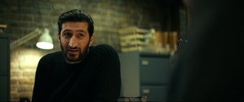 Movie still from “Journal 64” (2018), directed by Christoffer Boe – A person sitting in a chair; Close Up shot, Over the shoulder angle