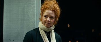 Movie still from “Journal 64” (2018), directed by Christoffer Boe – A person wearing a scarf; Close Up shot, Over the shoulder angle