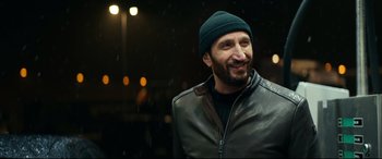 Movie still from “Journal 64” (2018), directed by Christoffer Boe – A man wearing a leather jacket and a beanie; Close Up shot, Over the shoulder angle