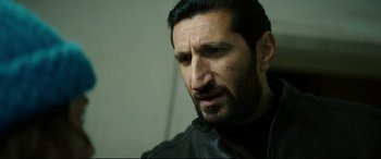 Movie still from “Journal 64” (2018), directed by Christoffer Boe – A person wearing a leather jacket; Close Up shot, Low angle