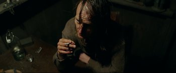Movie still from “Journal 64” (2018), directed by Christoffer Boe – A man sitting down with a cigarette in his mouth; Close Up shot, Over the shoulder angle