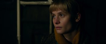 Movie still from “Journal 64” (2018), directed by Christoffer Boe – A person wearing a scarf; Close Up shot, Over the shoulder angle
