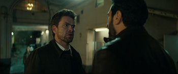 Movie still from “Journal 64” (2018), directed by Christoffer Boe – Two men are looking at one another in a room; Close Up shot, Over the shoulder angle