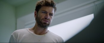 Movie still from “Journal 64” (2018), directed by Christoffer Boe – A person wearing a white shirt; Close Up shot, Low angle