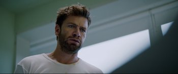 Movie still from “Journal 64” (2018), directed by Christoffer Boe – A person wearing a white shirt; Close Up shot, Low angle